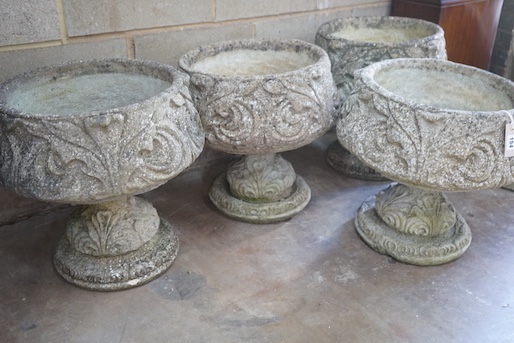 A matched set of four circular reconstituted stone garden planters, moulded with acanthus scrolls, diameter 44cm, height 47cm